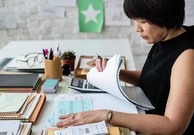 short haired woman doing paper works